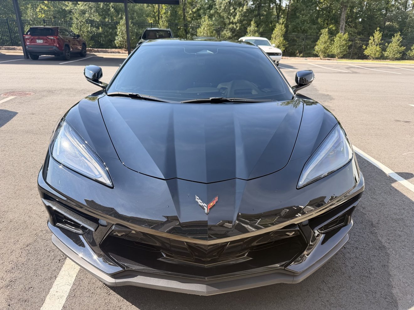 Glossy black Corvette C8 after an exterior detail, front view